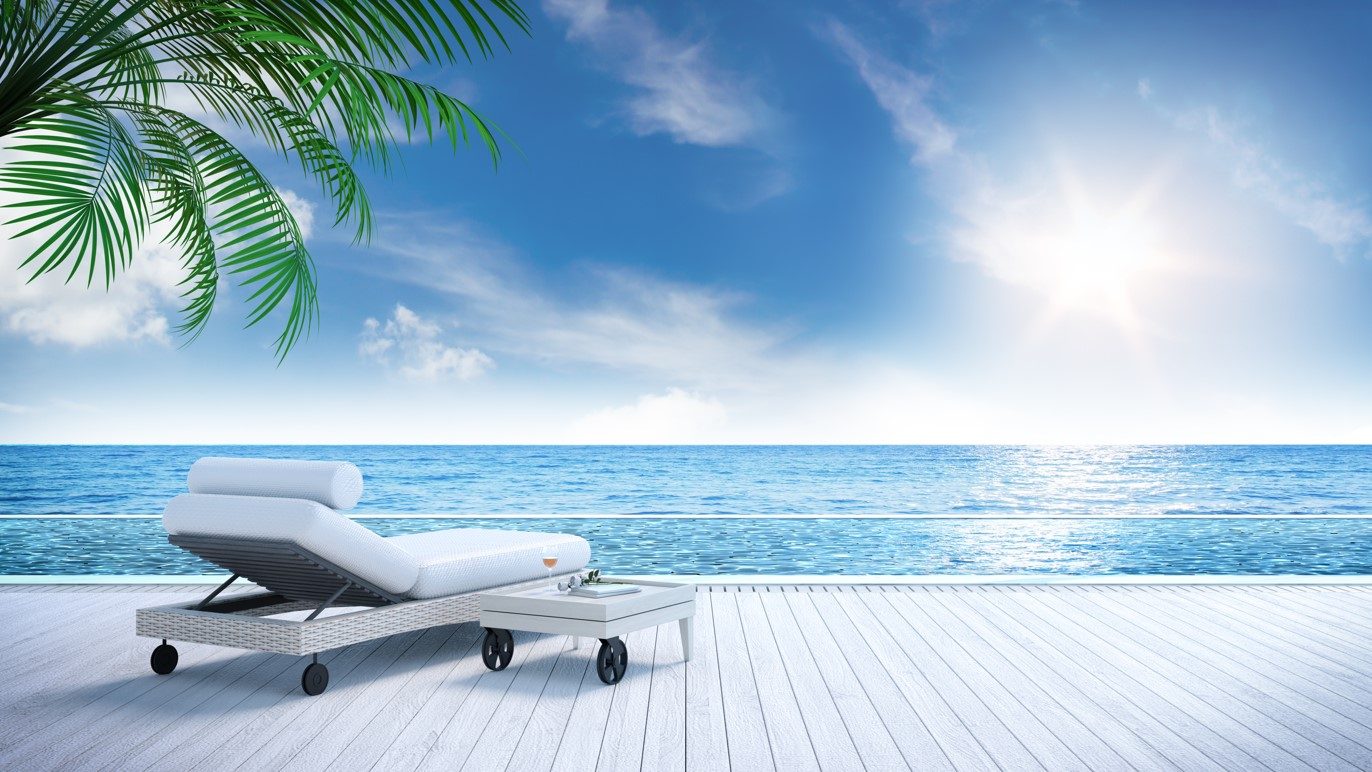 Empty sun lounger facing the ocean
